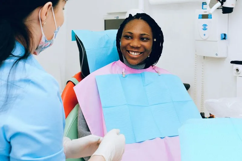 Woman in dentist chair, smiling